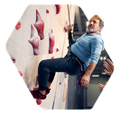 A man is on a rock climbing wall.
